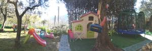 a childrens playground with a play set and a tree at Guesthouse Runcini in Ferentillo