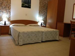 Postel nebo postele na pokoji v ubytování Palates Hotel