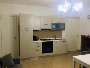 a kitchen with white cabinets and a stove top oven at Casa vacanze One in Frascineto