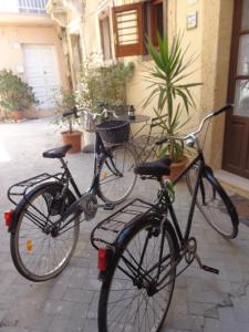 three bikes parked next to each other on a street at Casa Gaia Ortigia Holiday Home in Syracuse