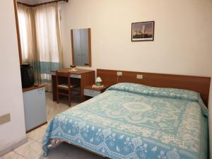 Katil atau katil-katil dalam bilik di Riccio Hotel