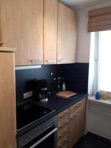 a kitchen with a black counter top and a stove at Ferienwohnungen Triebels in Aachen