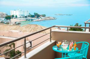 a balcony with a table with drinks on it at Sea Breeze Experience in Kavála