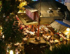 an overhead view of a restaurant with people sitting at tables at Villa Cha-Cha Banglumphu in Bangkok