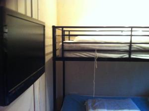 a room with two bunk beds and a window at Glangwna Holiday Park in Caernarfon