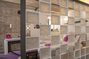 a wall of mirrors in a room with a fireplace at Domus Paradiso City Center in Rome