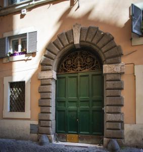 an entrance to a building with a green door at Domus Paradiso City Center in Rome