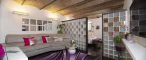 a living room with a couch and a table at Domus Paradiso City Center in Rome