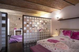 a bedroom with a large bed and a wall with mirrors at Domus Paradiso in Rome