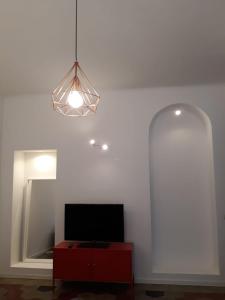 uma sala de estar com televisão e iluminação em Appartamento con vista em Milão
