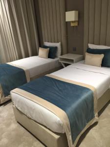 En eller flere senge i et værelse på HOTEL LES 3 VALLÉES