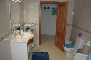 a bathroom with a toilet and a sink and a toilet istg at Ericeira Sunset Apartment in Ericeira