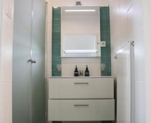 a bathroom with a white dresser and a mirror at Baum Apartments in Bad Tatzmannsdorf