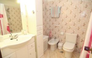 a bathroom with a white sink and a toilet at Apartamento Luz del Mar in Torrox Costa +10 photos