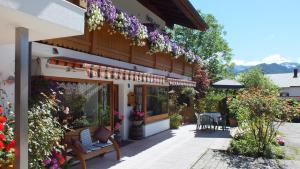 a house with flowers on the side of it at Gästehaus Amort Ferienwohnung in Ramsau