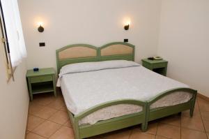 Ένα ή περισσότερα κρεβάτια σε δωμάτιο στο Albergo Cenni