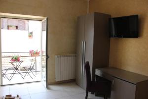 a kitchen with a desk and a refrigerator and a table at B&B Casa Venezia in Bernalda