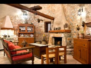 a kitchen with a stone wall with a fireplace at Arapakis Historic Castle in Pyrgos Dirou
