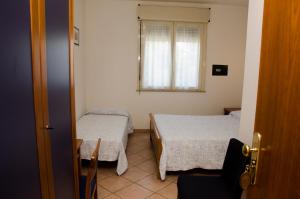 Ένα ή περισσότερα κρεβάτια σε δωμάτιο στο Albergo Cenni