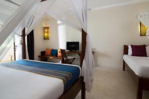 Cama ou camas em um quarto em Fruit & Spice Wellness Resort Zanzibar