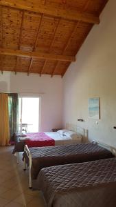Postel nebo postele na pokoji v ubytování Gardenos Hotel