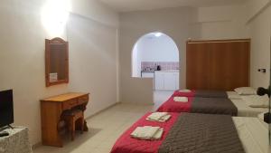 Postel nebo postele na pokoji v ubytování Gardenos Hotel
