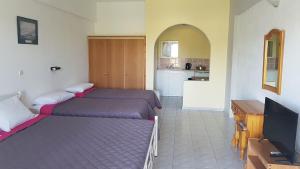 Postel nebo postele na pokoji v ubytování Gardenos Hotel
