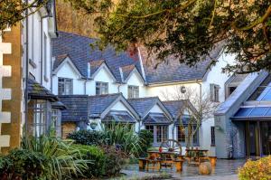 a row of houses with tables and chairs in a courtyard at Wild Pheasant Hotel & Spa in Llangollen