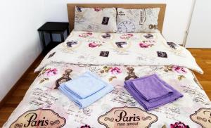 ein Bett mit rosa und lila Bettwäsche und Kissen in der Unterkunft a beautiful, big and cozy room in the city center in Wien