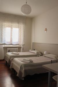 Postel nebo postele na pokoji v ubytování B&B Domus Benedicta