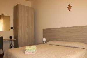Postel nebo postele na pokoji v ubytování B&B Domus Benedicta