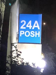 a sign on the side of a building at night at Posh Apartments Business Hotel in Ikeja
