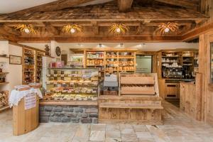 a shop with wooden walls and ceilings and a store with food at Familien- und Vitalhotel Mühlpointhof in Lofer