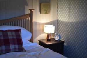 
a bed with a lamp on top of it next to a lamp post at Ardmore House B&B in Lochinver
