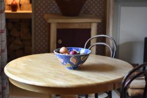 
a bowl of fruit sitting on top of a wooden table at Ardmore House B&B in Lochinver
