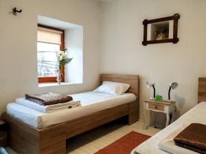 a small bedroom with a bed and a window at Kulla Dula Guesthouse in Gjakove