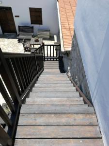 a wooden staircase leading to a patio with a table at Romios Apartments in Kalavasos