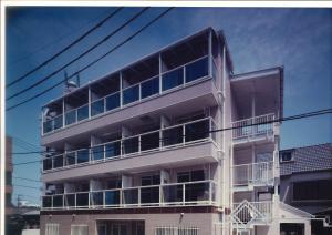 un edificio blanco alto con muchas ventanas en Melody Heim 2C, en Tokushima