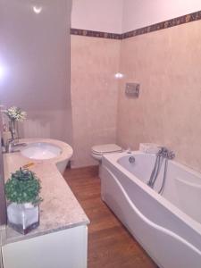 a bathroom with a tub and a toilet and a sink at Franciacorta Suite in Corte Franca
