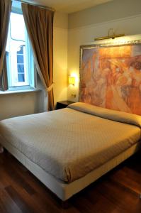 Ένα ή περισσότερα κρεβάτια σε δωμάτιο στο Albergo Sant'Emidio