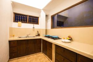 a kitchen with a sink and a stove at Pondok Permata Homestay in Ubud +73 photos
