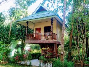 a tree house in the middle of a forest at Macura Resort in Ko Chang