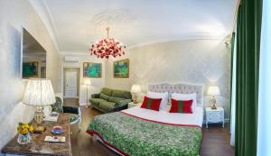 a bedroom with a bed and a living room at Rossi Boutique Hotel in Saint Petersburg