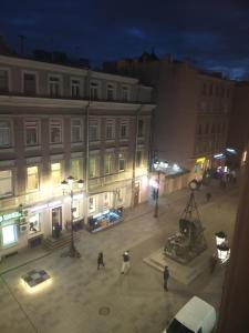 a group of people walking in a city at night at Nevsky 126 Guest House in Saint Petersburg