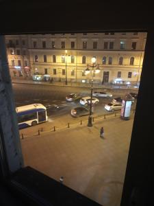 a view of a city street at night with buses at Nevsky 126 Guest House in Saint Petersburg