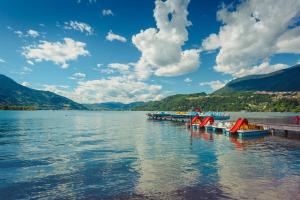 a group of boats parked at a dock on a lake at Casa Santa Maria in Folgaria