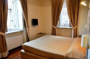 Ένα ή περισσότερα κρεβάτια σε δωμάτιο στο Albergo Sant'Emidio