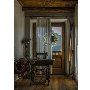 een kamer met een tafel en een raam bij B&B Rossodisera in Domegge di Cadore