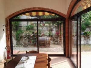 モンテメラノにあるAgriturismo Norianinoのテーブル付きのパティオへ続く開放的なドア