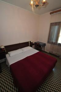 Łóżko lub łóżka w pokoju w obiekcie Locanda Sant'Anna Hotel